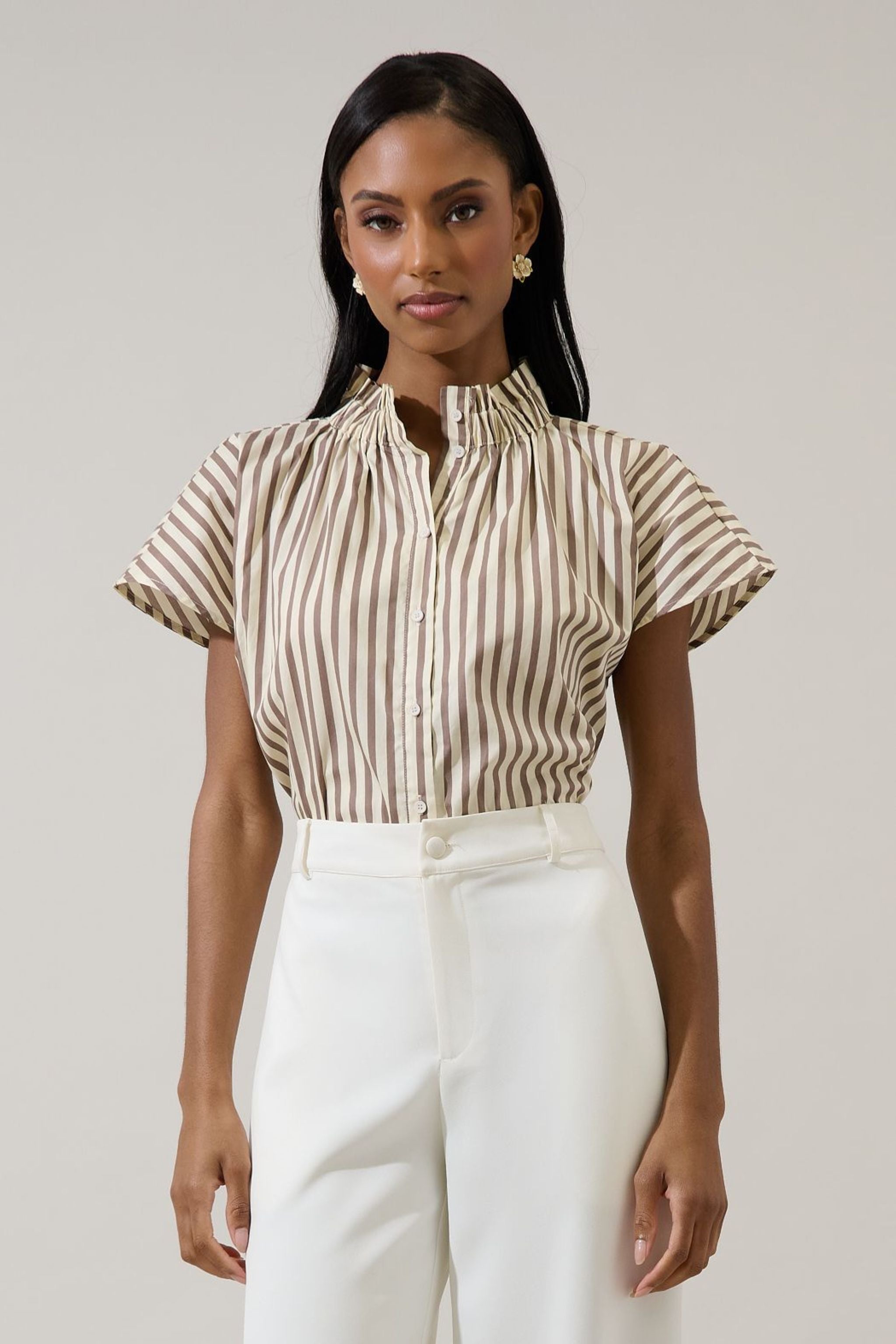 Woman wearing a brown and cream striped shirt