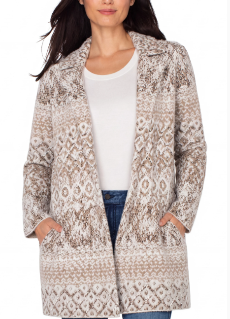 Model wearing a beige and cream shibori print open-front coatigan with a notched collar and pockets over a white top and jeans.