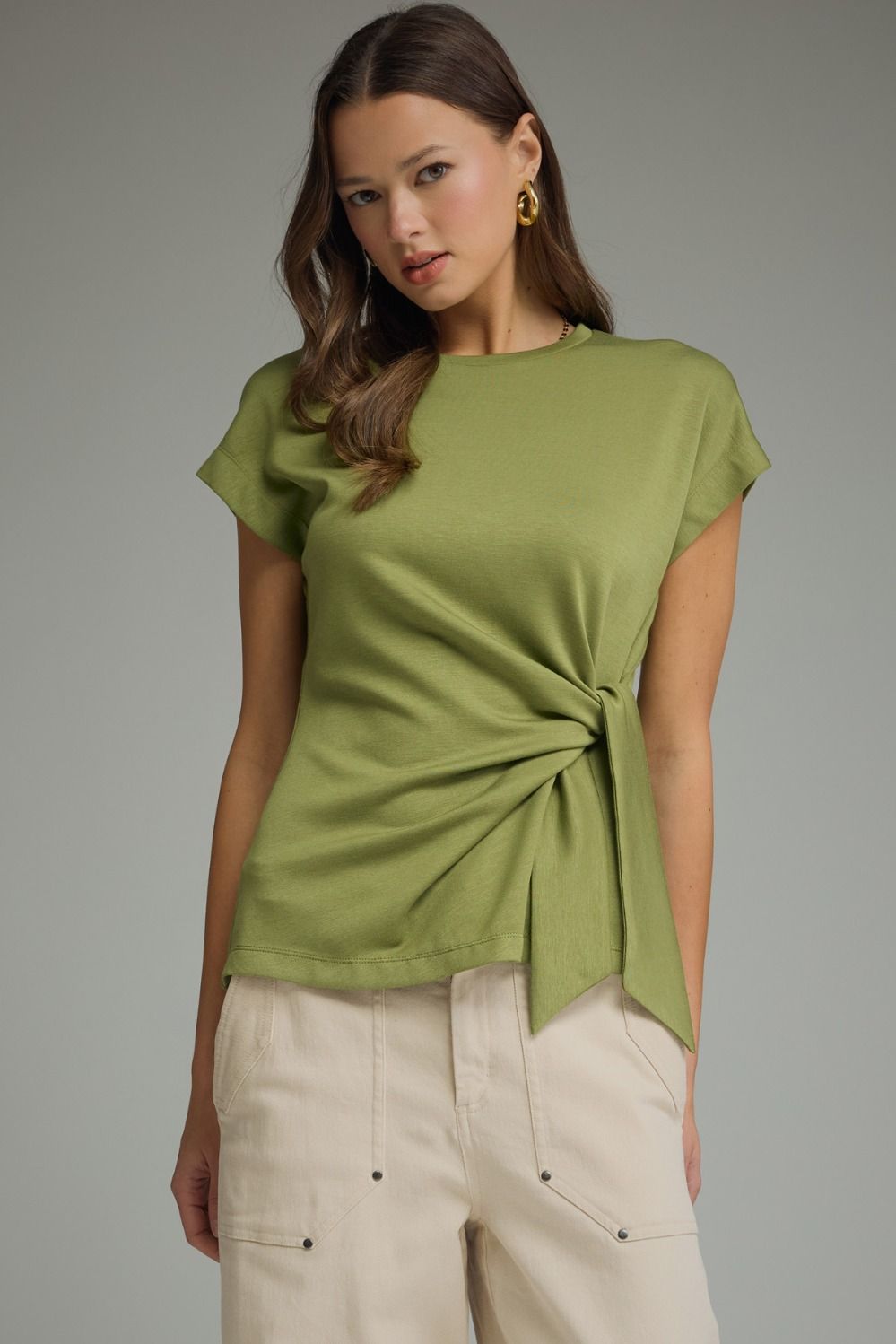 Light olive short-sleeve top with round neckline and self-tie bow detail at side waist.