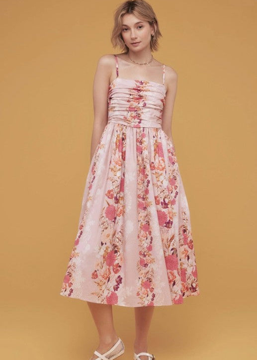 Woman wearing a floral dress pink with ruched fabric