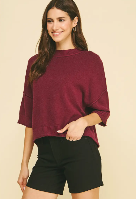The sweater you'll reach for on repeat — this tan crop knit strikes the perfect balance between cozy and put-together, with a drop shoulder silhouette and mock neckline that feel relaxed without looking casual.