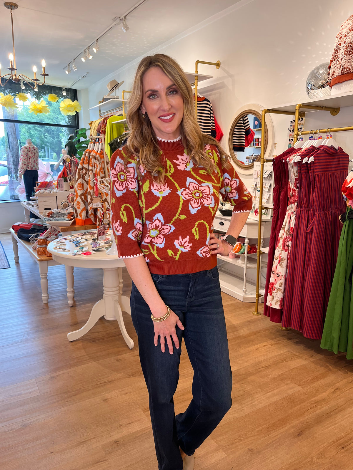 Shop a brown floral knit top with short sleeves and scalloped trim, an easy polished choice for casual days, lunch dates, and the office.