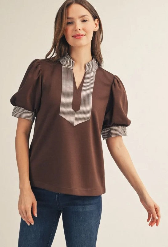 Brown short puff sleeve top with cream and brown striped V-neck bib accent, striped trim on collar and cuffs, high neckline, structured collar, crisp woven construction, relaxed fit.