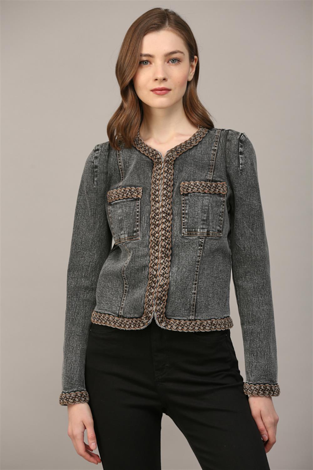 Cropped denim jacket with braided trim detailing along V-neckline, front placket, patch pockets, and cuffs; slight puff shoulder; fitted silhouette.