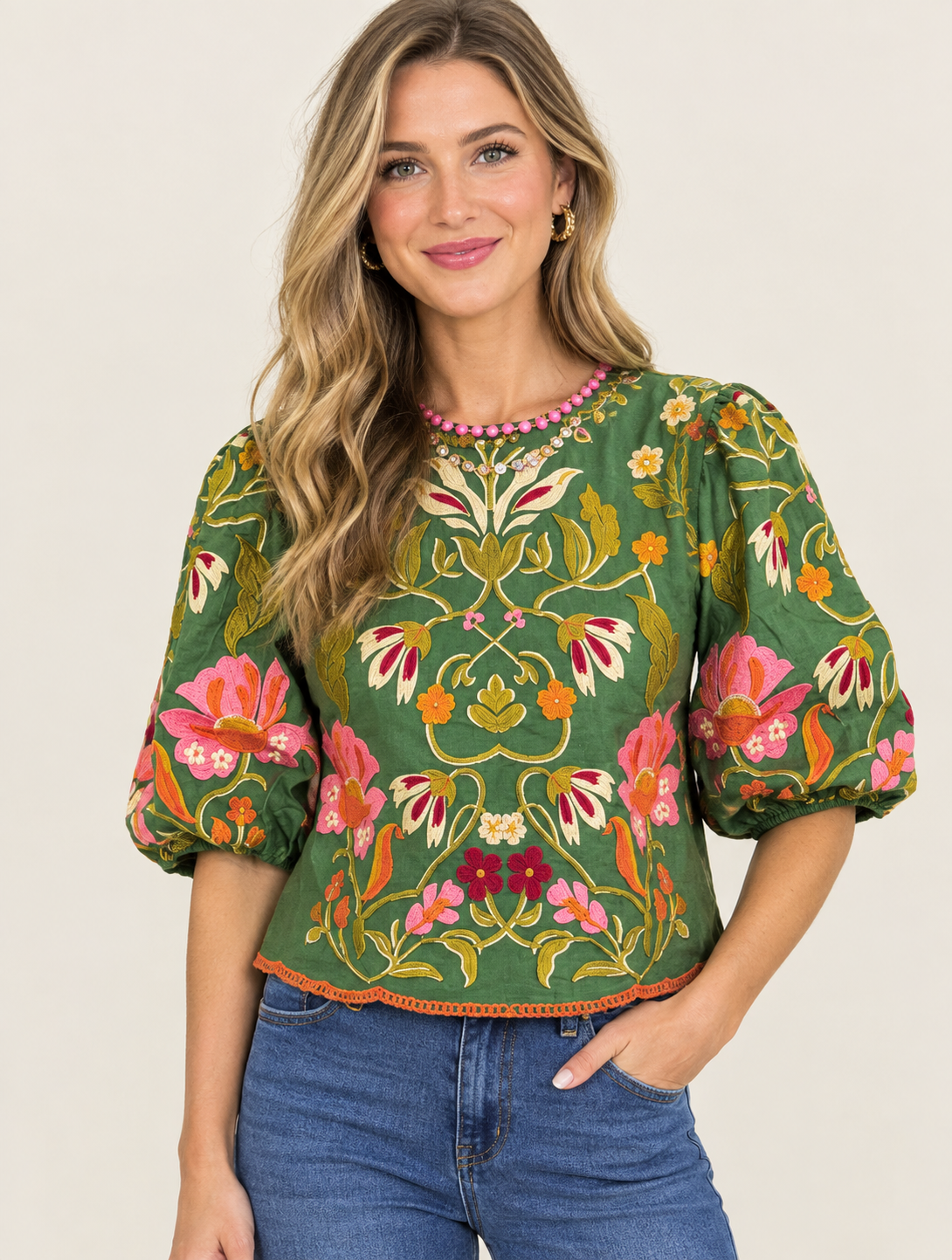 Colorful floral motifs cover a rich olive-green base, making it the kind of statement piece top. 
