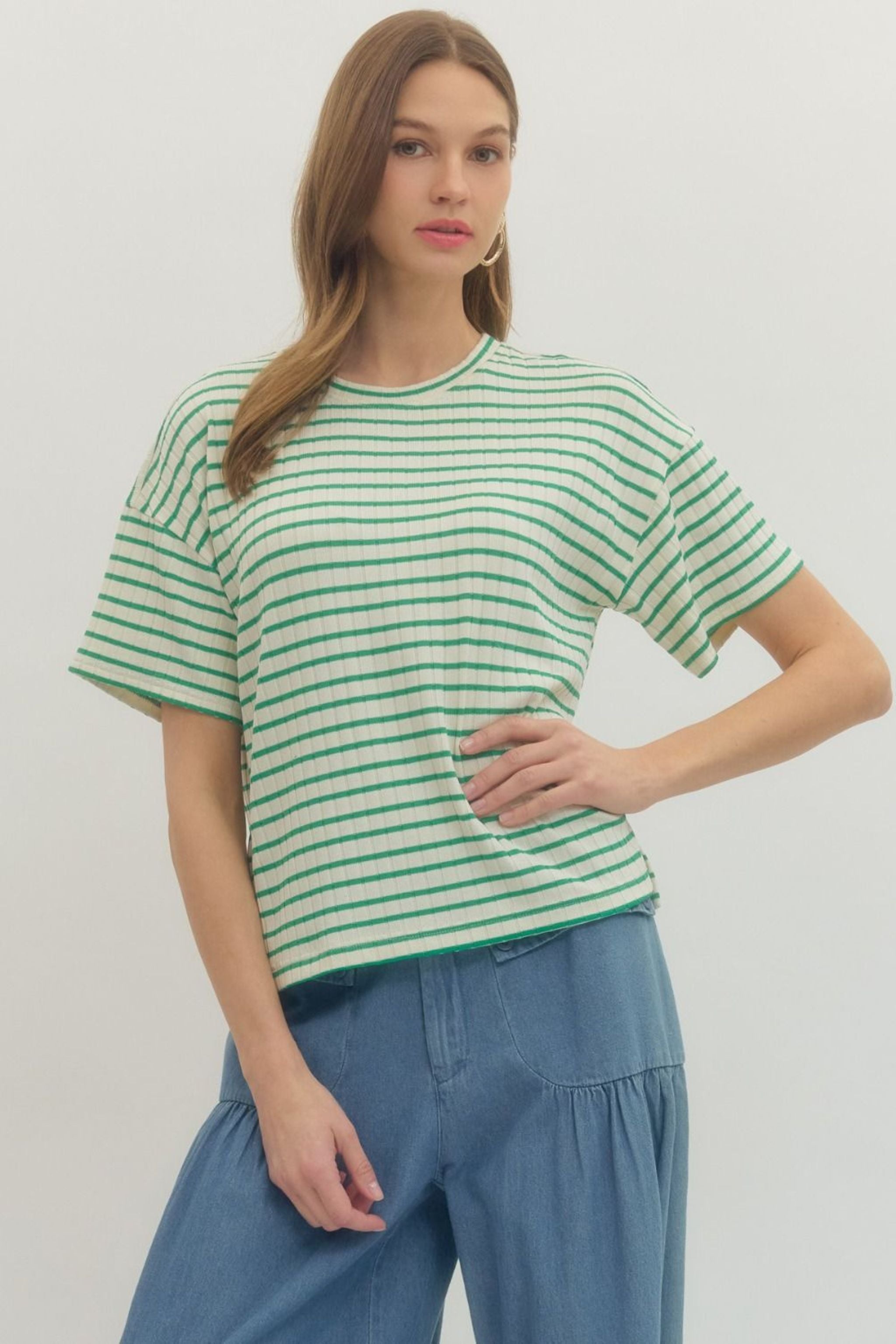 Woman wearing a green and white striped shirt 