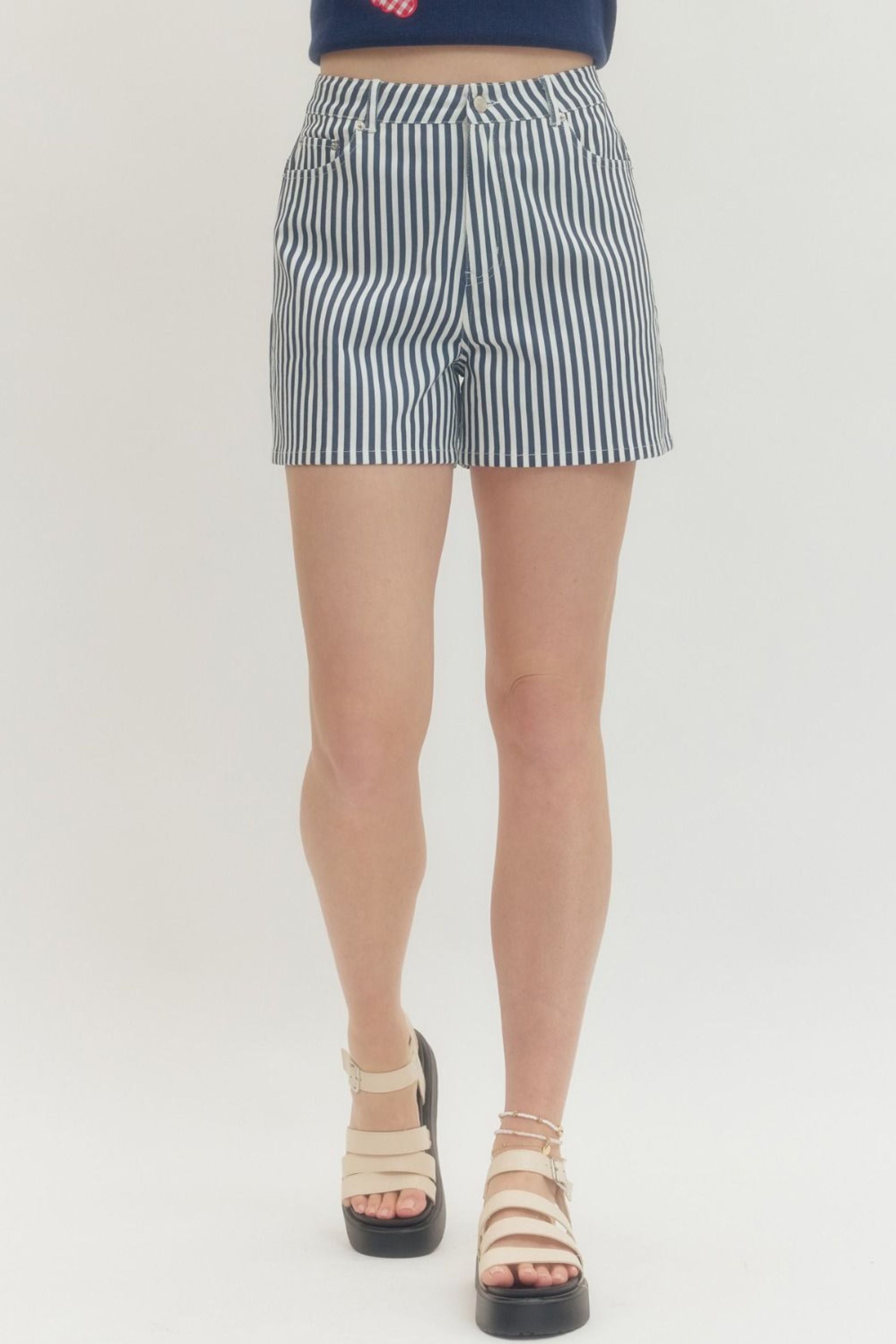 Person wearing a navy and white striped shorts