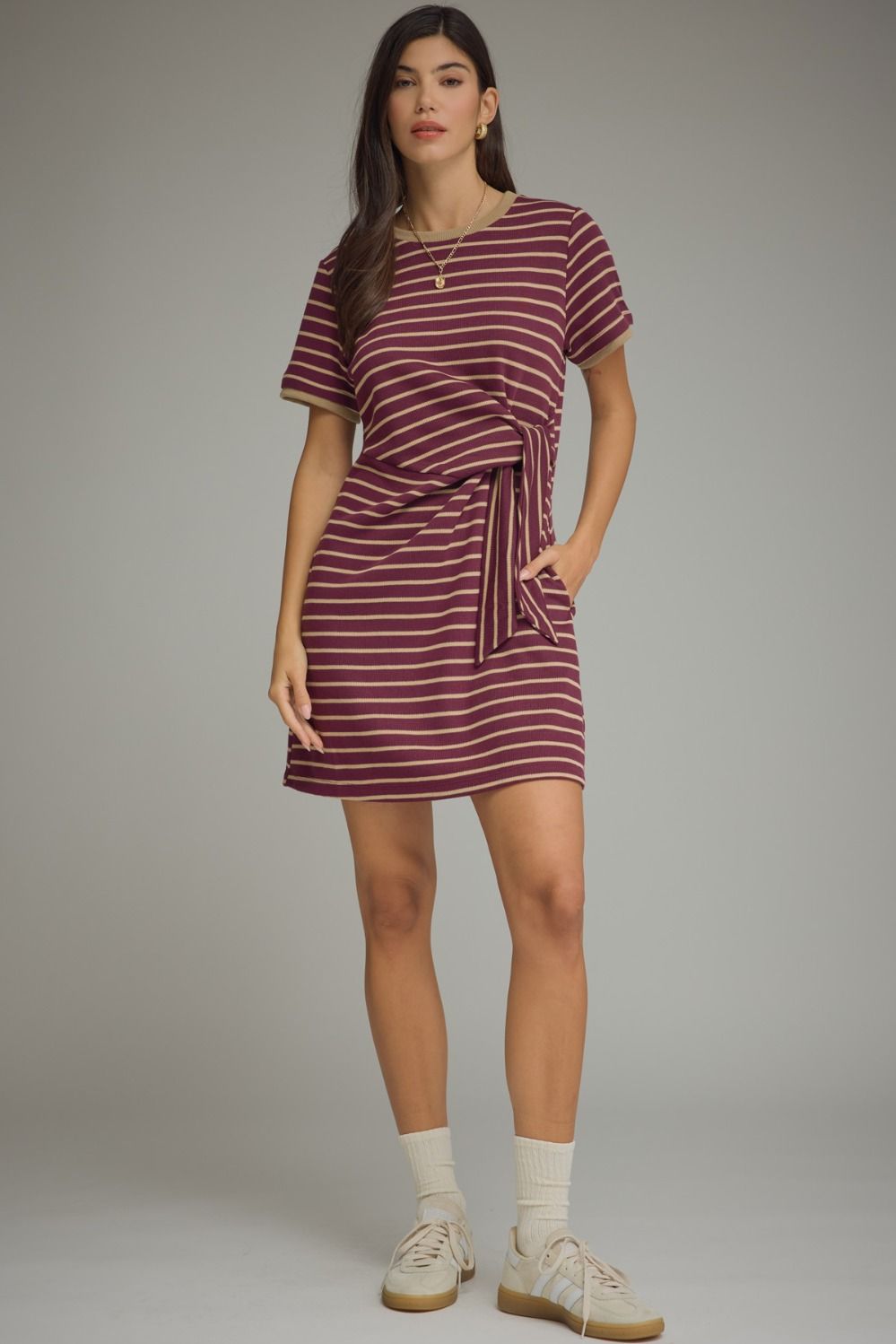 Plum and cream stripe short sleeve mini dress with side-tie waist knot, contrast ribbed neckline and cuffs, and side pockets on model 