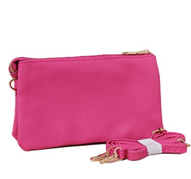 Add a touch of sophistication to your ensemble with this pink faux leather purse, complete with a zipper closure and strap. 