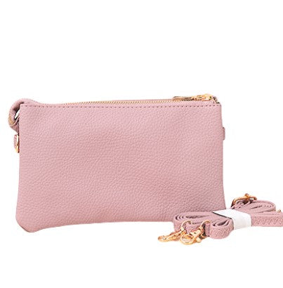 Stylish pink faux leather purse with a convenient zipper closure and a chic strap for a touch of elegance.