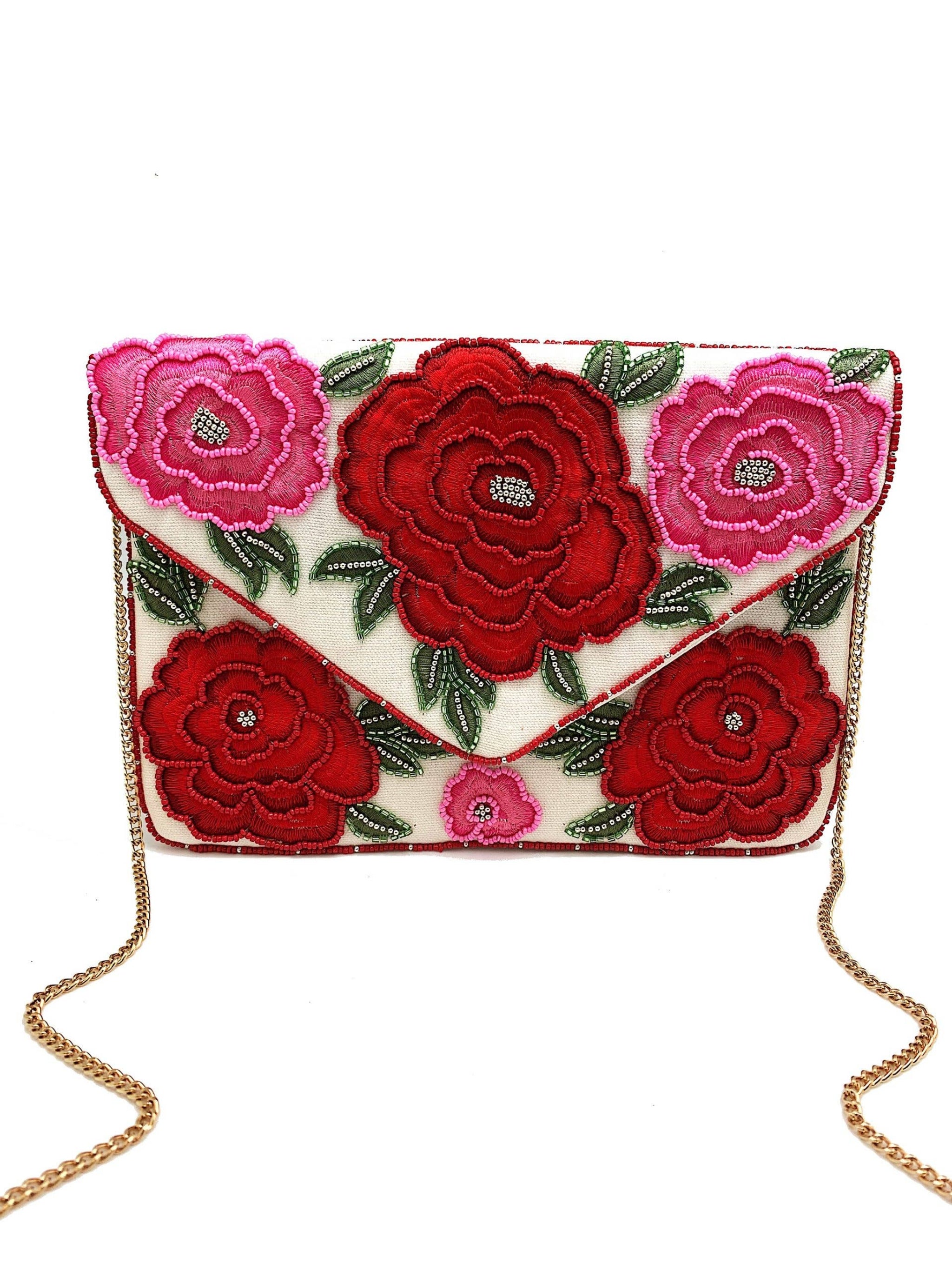 Floral embroidered clutch bag with red and pink flowers on a white background